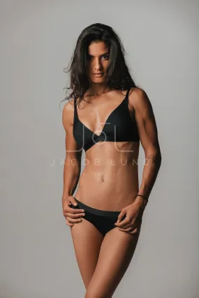 Attractive sultry young woman in black underwear